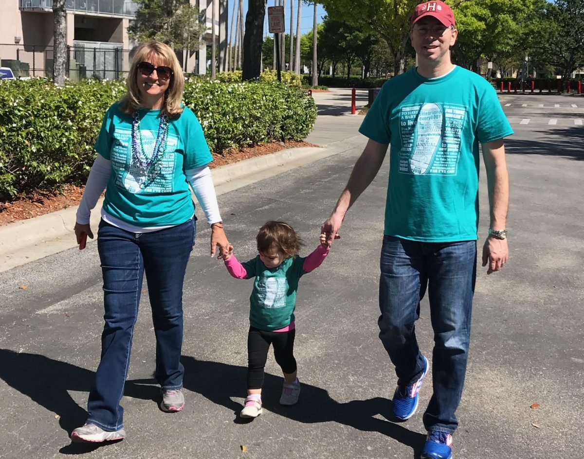 image of parents walking with their young child for a eating disorder fundraising event