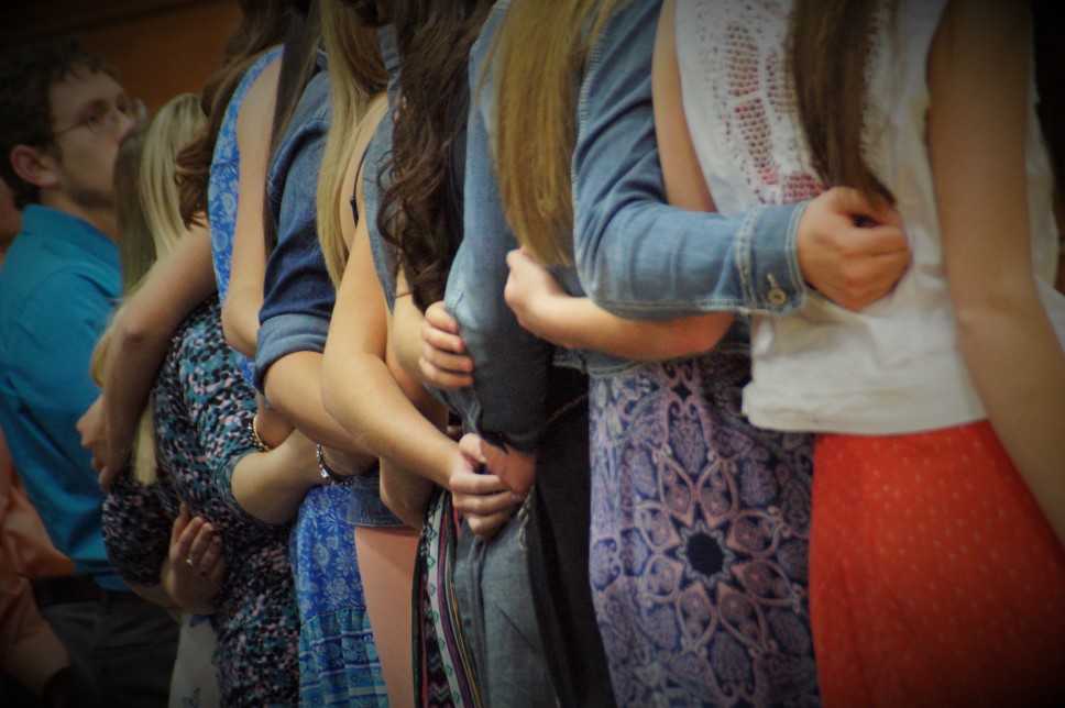 image of high school seniors hugging each other in a single file line