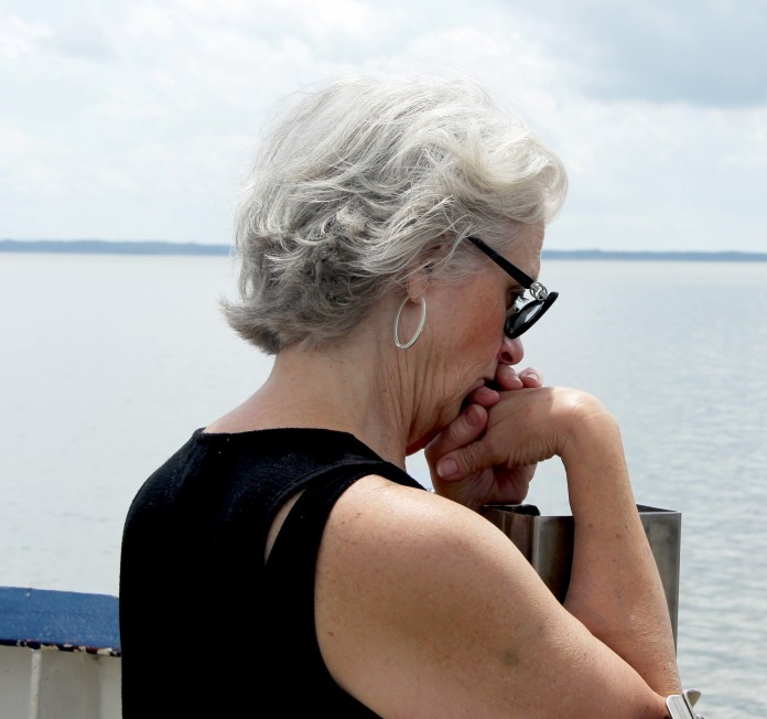 image of an older woman on the docks thinking and reflecting about eating disorders