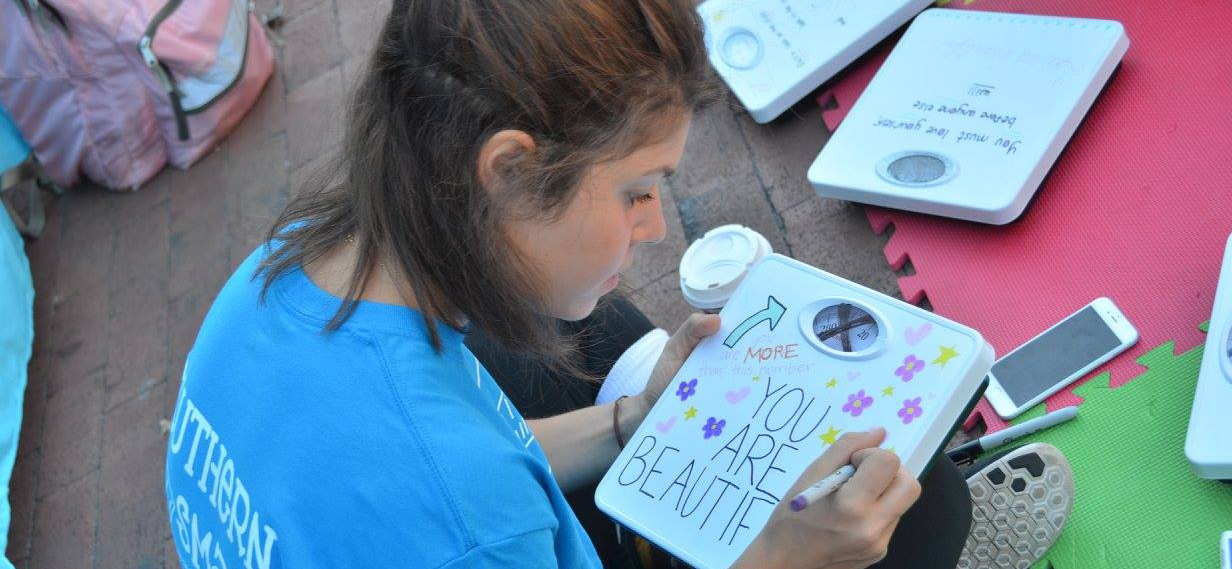 image of a young girl decorating a weight scale