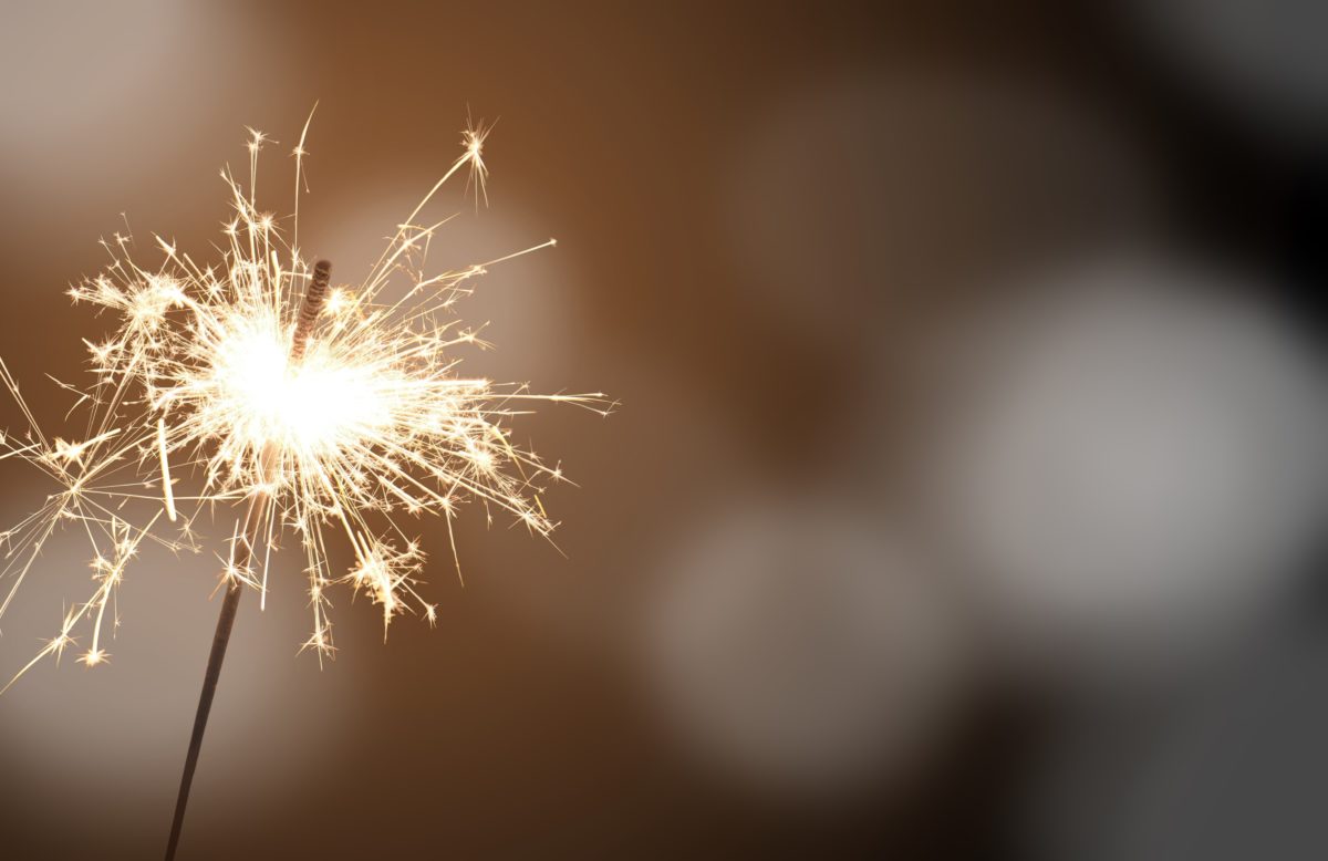 image of a sparkler against a blurry background