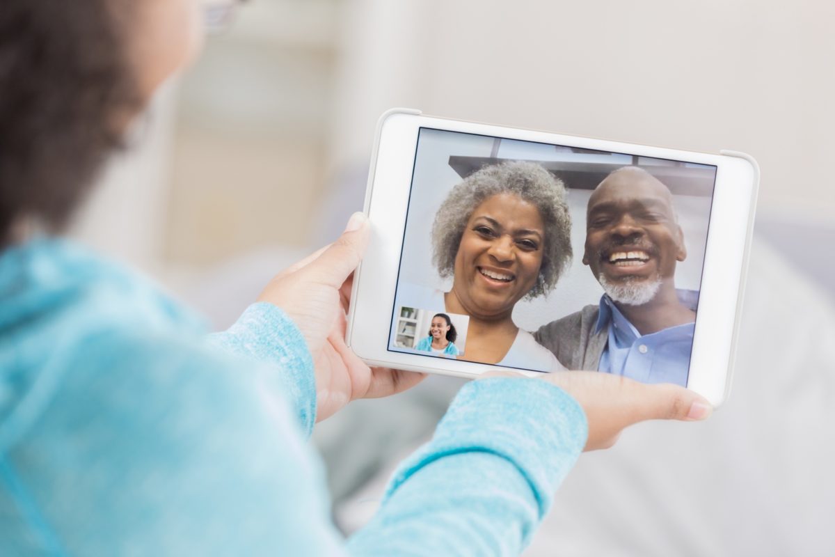 image of an older couple video chatting with their child on an ipad