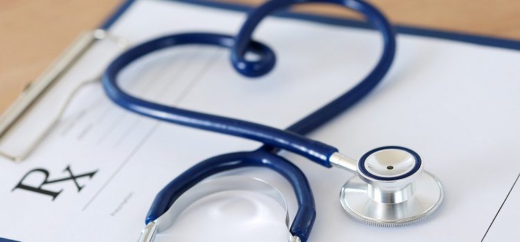image of a doctor's stethoscope on top of a prescription pad