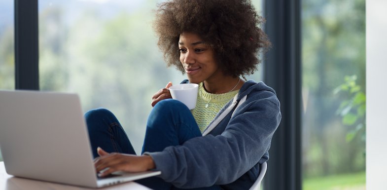 image of a young woman drinking coffee while receiving therapy services online