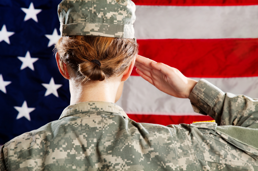 image of a female soldier saluting an american flag