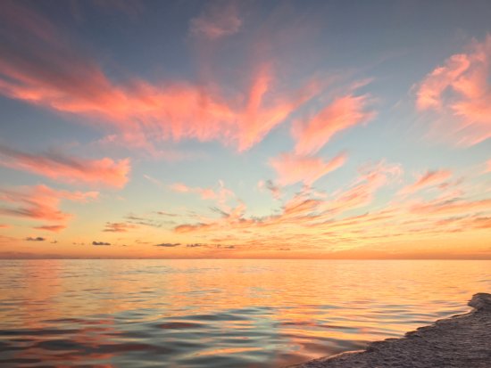 image of a low sunset with bright pink clouds