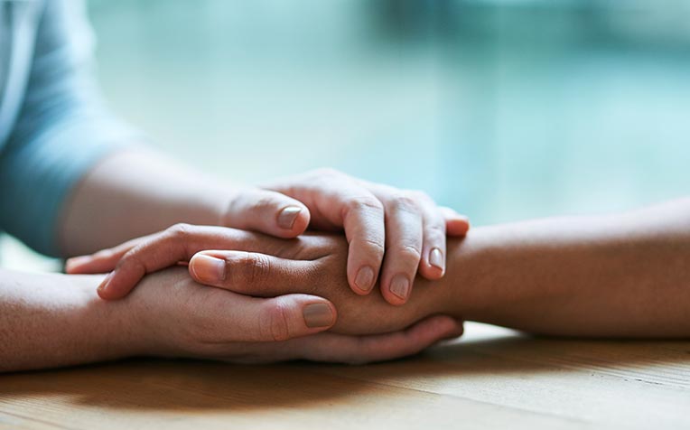 image of one hand holding another in support for eating disorders