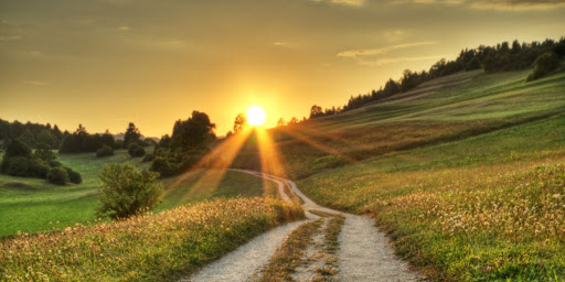 image of a sunset over a grassy hill representing a spiritual journey through eating disorders