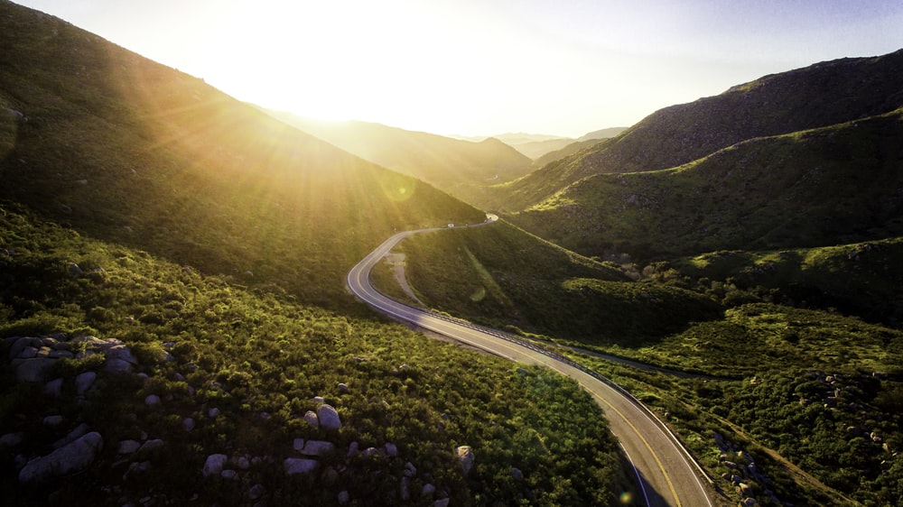 winding road amongst green valley