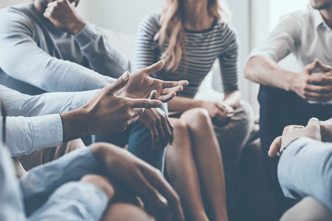 group of people sit in a circle