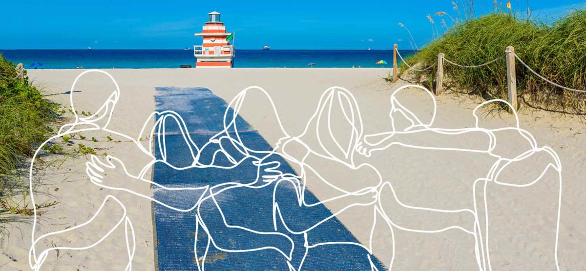 white outline of people hugging in front of beach