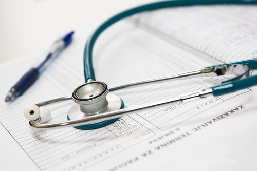 Stethoscope and pen on top of medical form