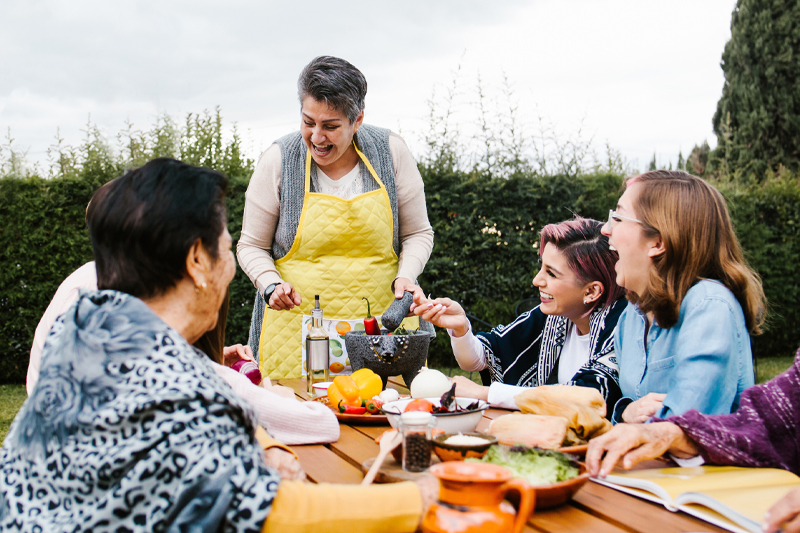 Latin mother and daughter cooking together mexican food at home in Mexico city