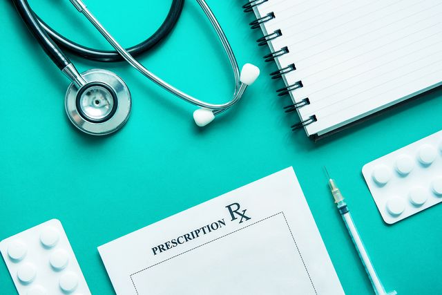 Blue medical background with prescription pad, stethoscope, and notebook