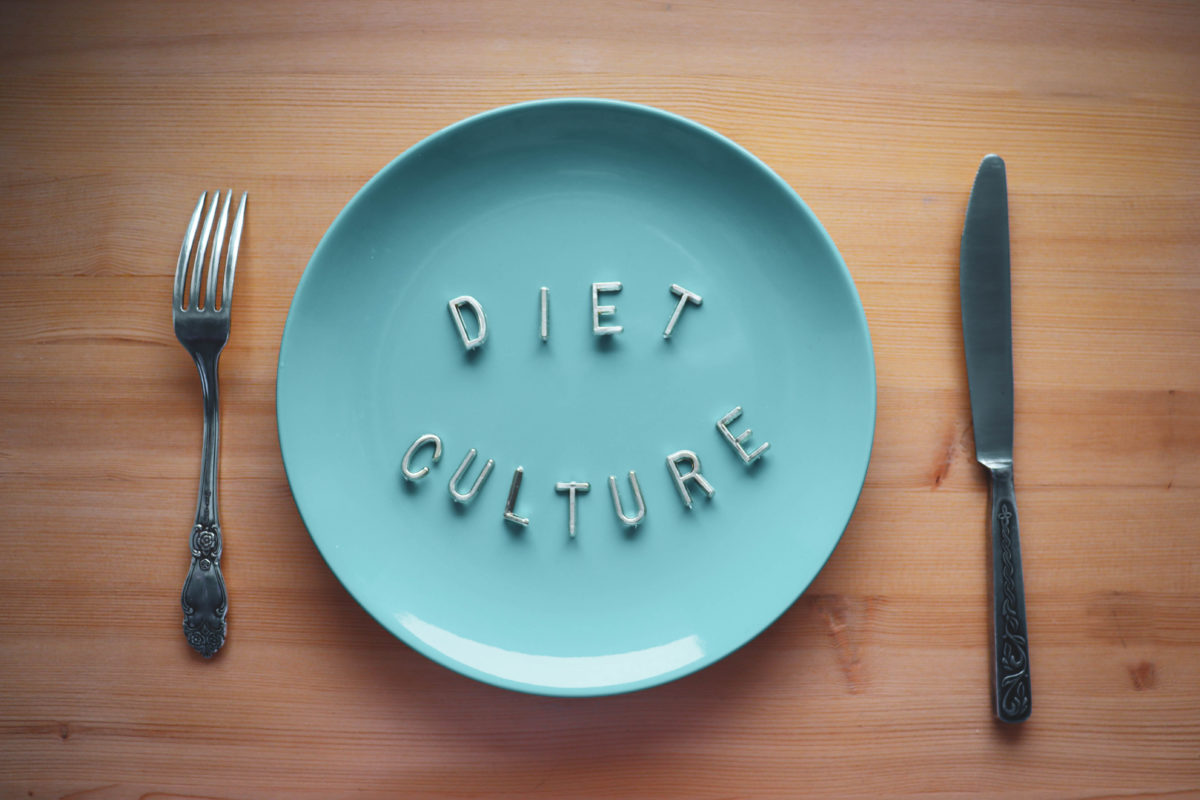 A Blue Plate with a fork and knife on each side. Plate reads 