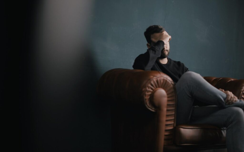 man in distress on couch