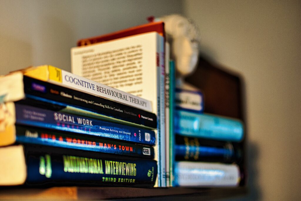 person out of focus behind books