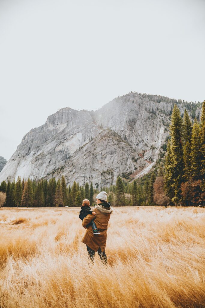 person in field with child