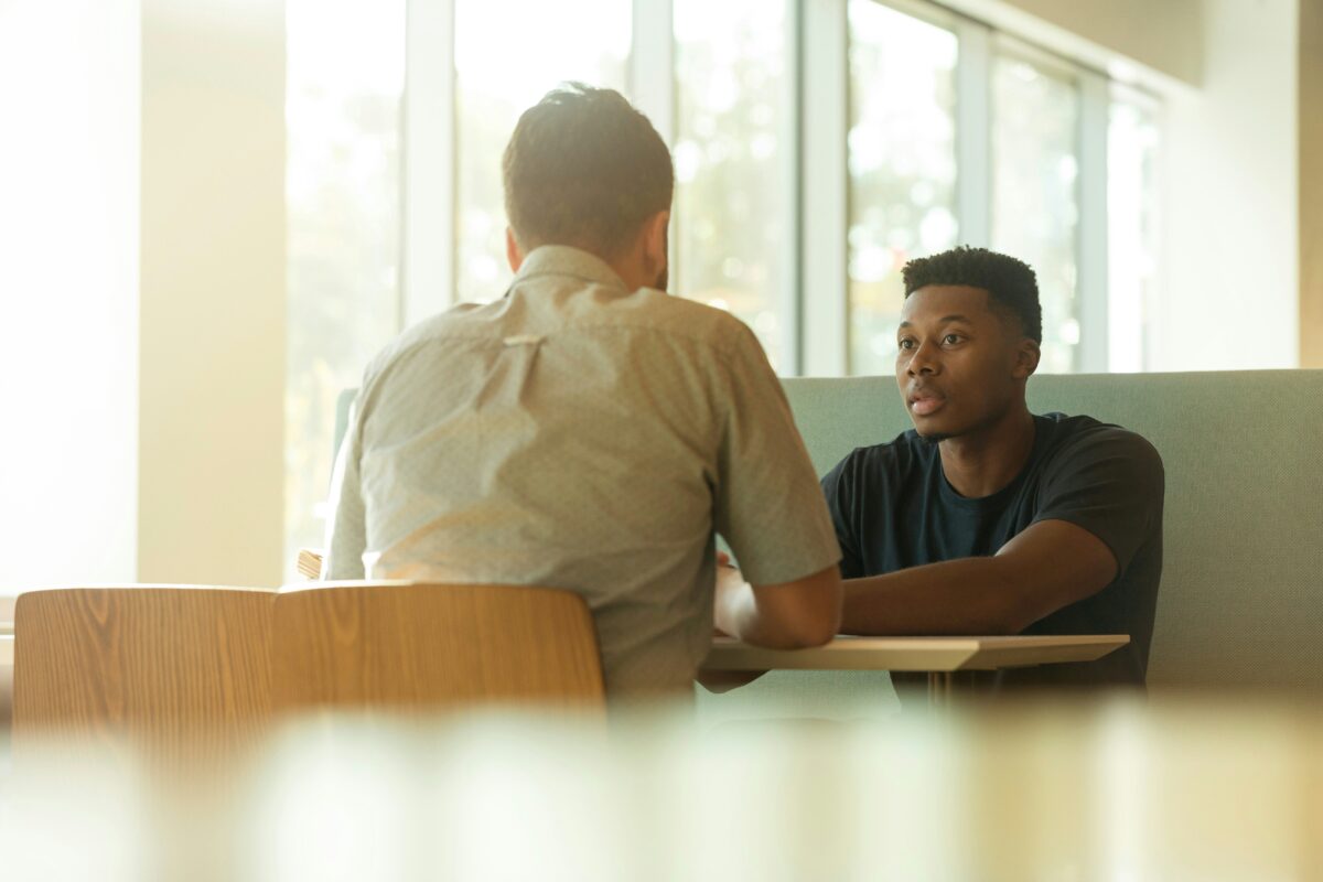 two men sitting across from each other
