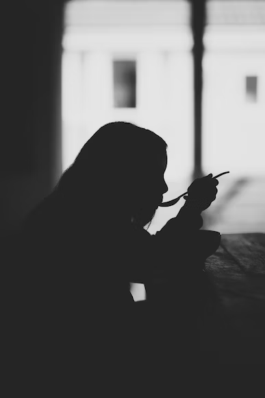 woman slurping from spoon