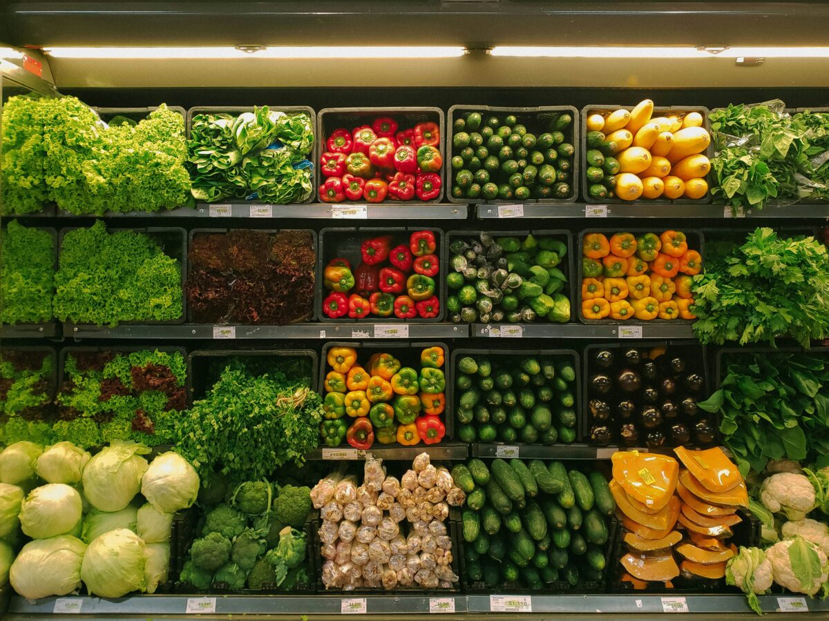 A grocery store aisle displaying vegetables.