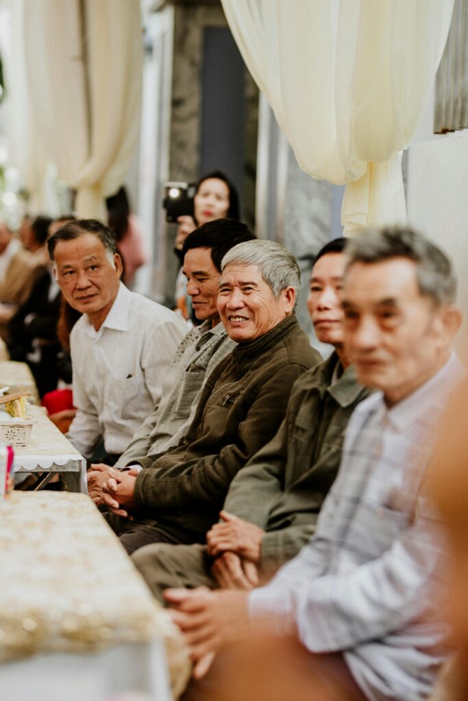 Group of older adults look at the camera while sitting at a table