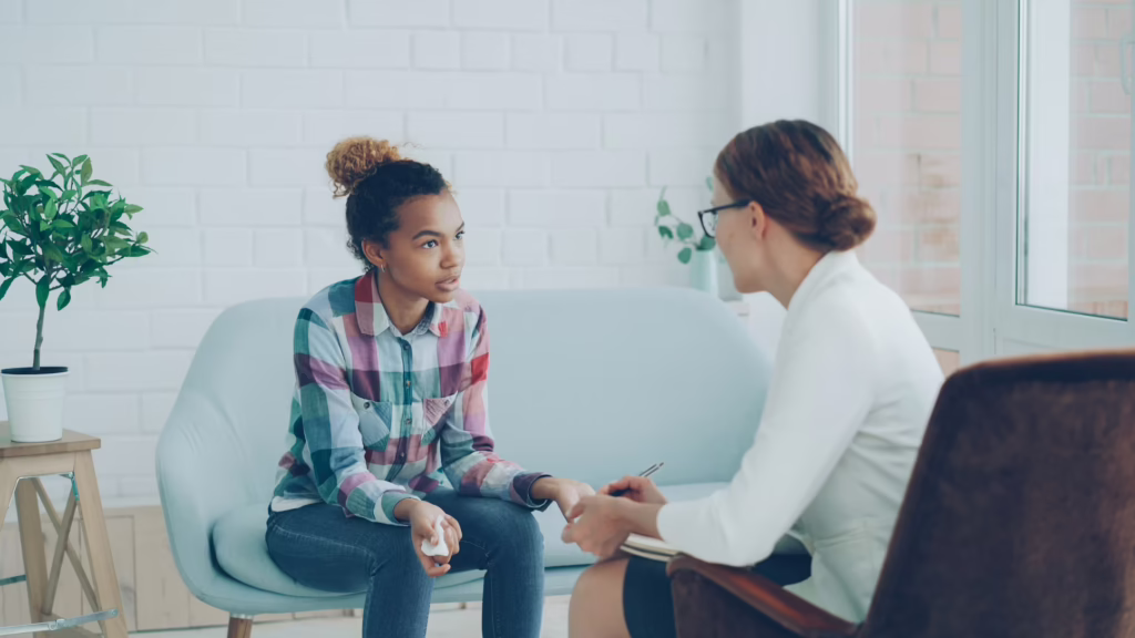 2 women sitting and discussing a topic