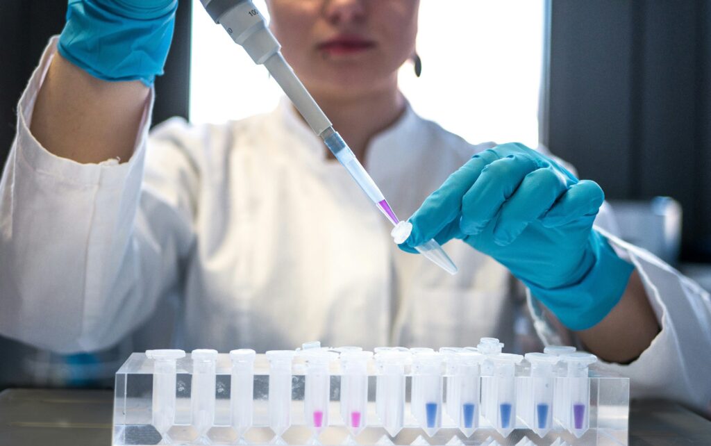 A researcher places unknown substance into testing device