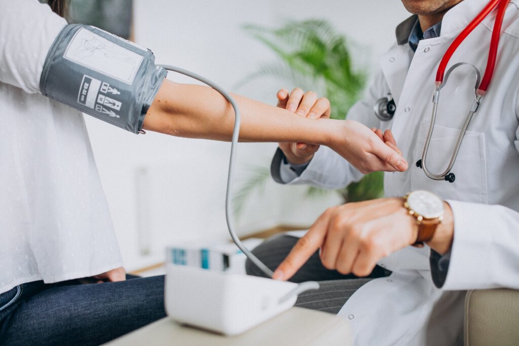 Close up image of a doctor taking a patients blood pressure