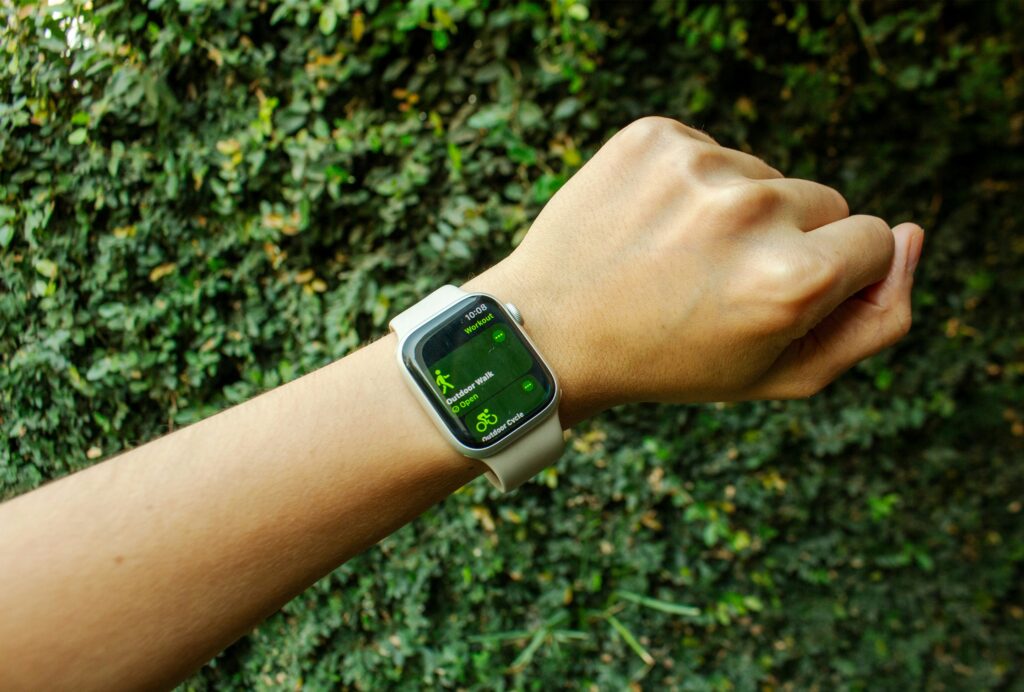 A person uses a smart watch outside