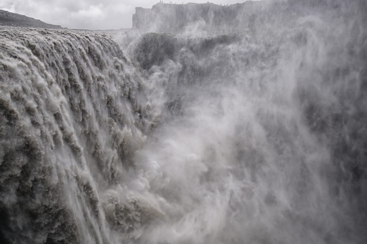 Water rushes down an immense waterfall