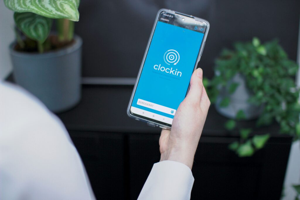 Person looks at a time tracking app on their phone.